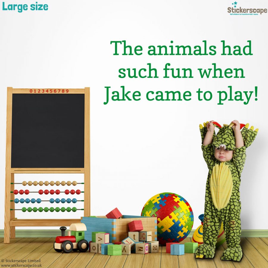 Personalised jungle quote wall sticker, jungle wall stickers. This sticker is in green text saying "The animals had such fun when Jake came to play!" The sticker has been placed in a playroom scene next to a small blackboard and above a child in a dinosaur costume.