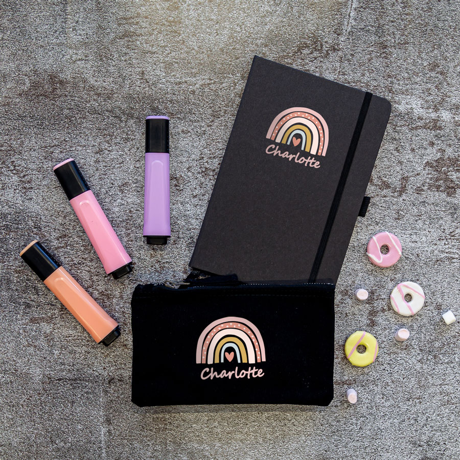 Rainbow heart back to school mini bundle. Image showing black notebook and black pencil case with pastel pink rainbow with heart in centre and name in pink coloured text below.