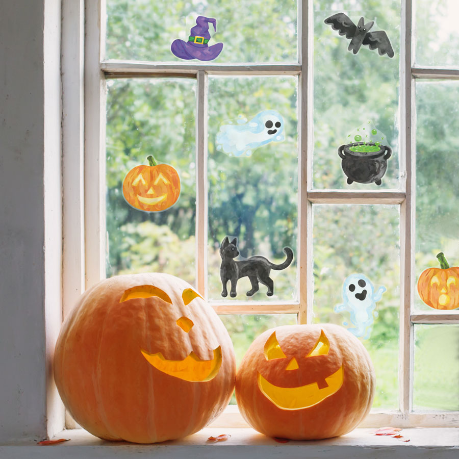 cute halloween window stickers, halloween window stickers, image shows stickers pasted on a window with two pumpkins in front