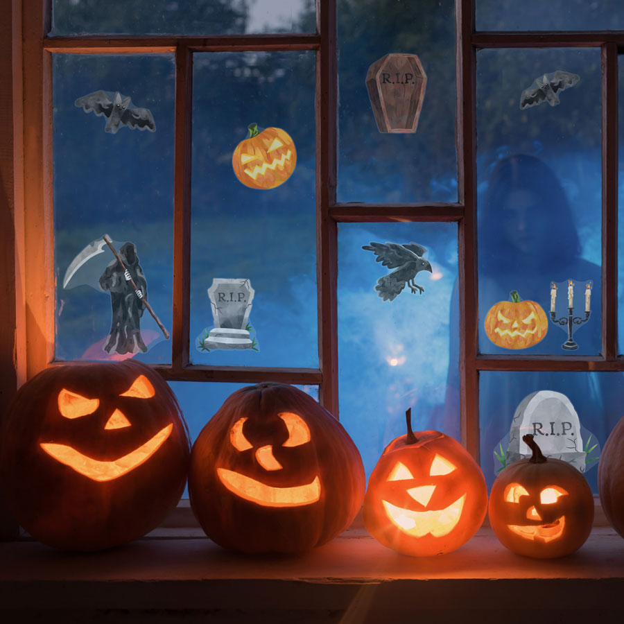 scary halloween window stickers, halloween window stickers, image shows stickers pasted on a window with four pumpkins in front and a spooky ghost outside