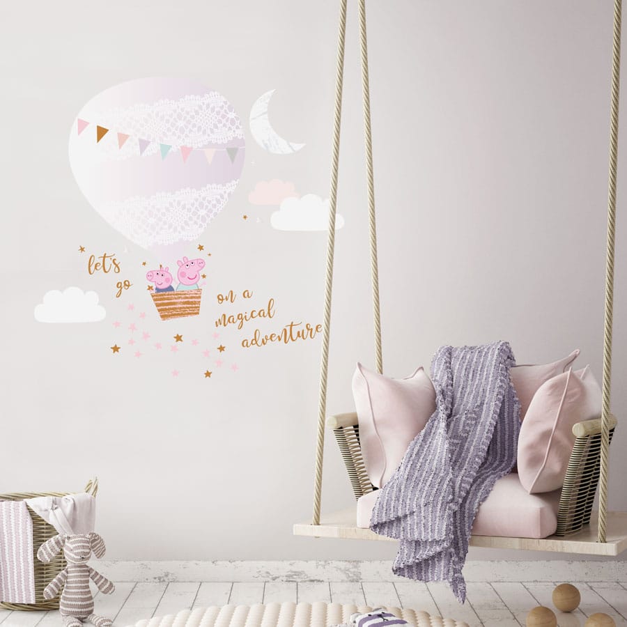 Magical adventure with Peppa wall sticker regular shown on a light beige wall behind a hanginig swing with light coloured blankets