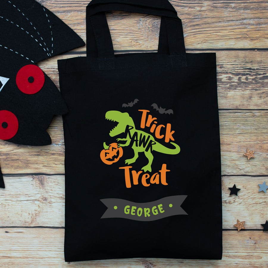 Personalised dinosaur trick or treat bag (Black) perfect for Halloween trick or treat featuring a dinosaur and personalised banner