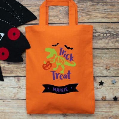 Personalised dinosaur trick or treat bag (Orange) perfect for Halloween trick or treat featuring a dinosaur and personalised banner