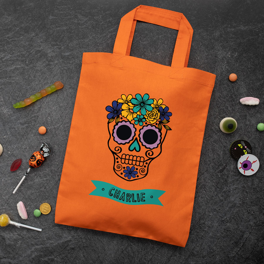 Personalised skull trick or treat bag (Orange) perfect for Halloween trick or treat featuring a skull or calavera and personalised banner