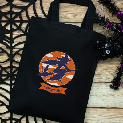 Personalised witch and cat trick or treat bag (Black) perfect for Halloween trick or treat featuring a witch and cat on a broomstick and personalised banner