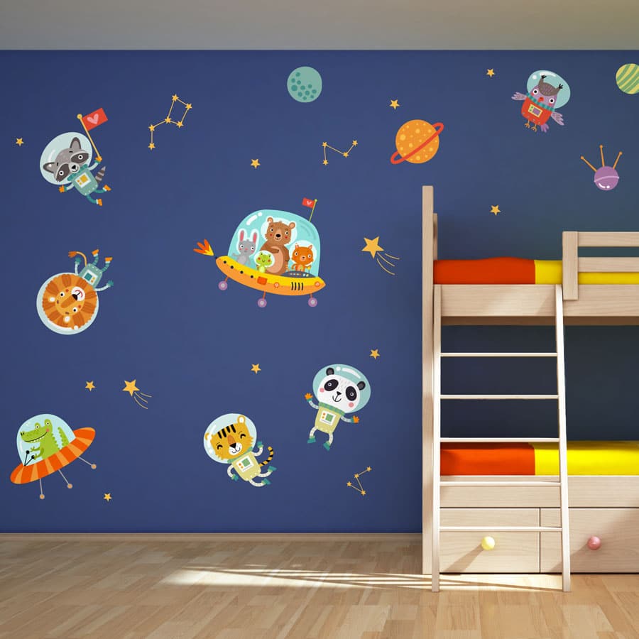 Space animals wall stickers. Image displays a collection of jungle animals inside spaceships and wearing spacesuits as well as constellations and colourful planets. The stickers have been placed on a dark blue bedroom wall around a wooden bunk bed.