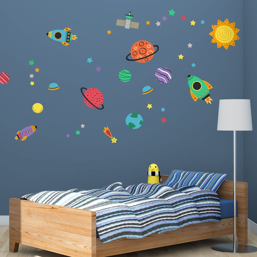 Colourful space wall stickers pack on a dark blue wall in a boys bedroom perfect for decorating with a space theme