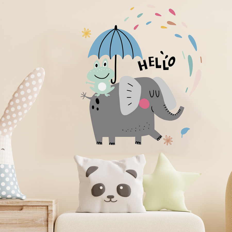 Fun elephant wall sticker regular on a light beige wall, above apale sofa with light coloured cushions