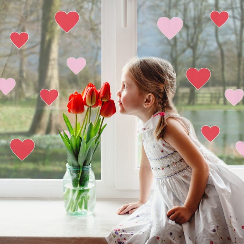 Pink and red heart window stickers with girl smelling flowers perfect for decorating for Valentines Day
