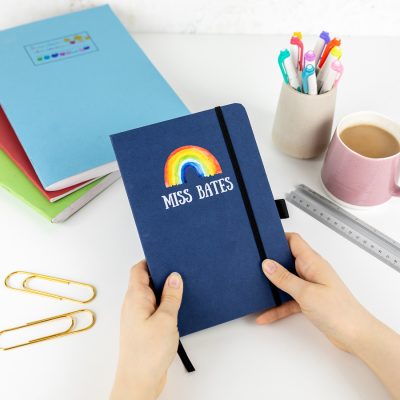 Personalised rainbow notebook in blue features a rainbow design with personalised name underneath and is a perfect gift for a teacher or teaching assistant to say thank you