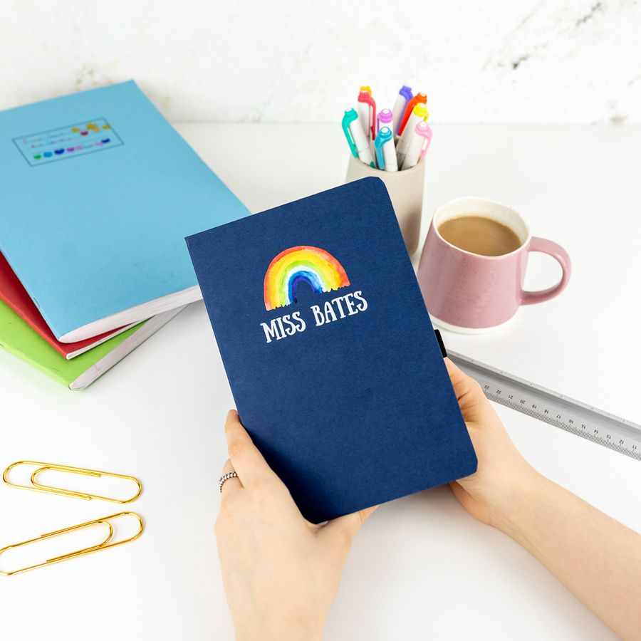 Personalised rainbow notebook in blue features a rainbow design with personalised name underneath and is a perfect gift for a teacher or teaching assistant to say thank you