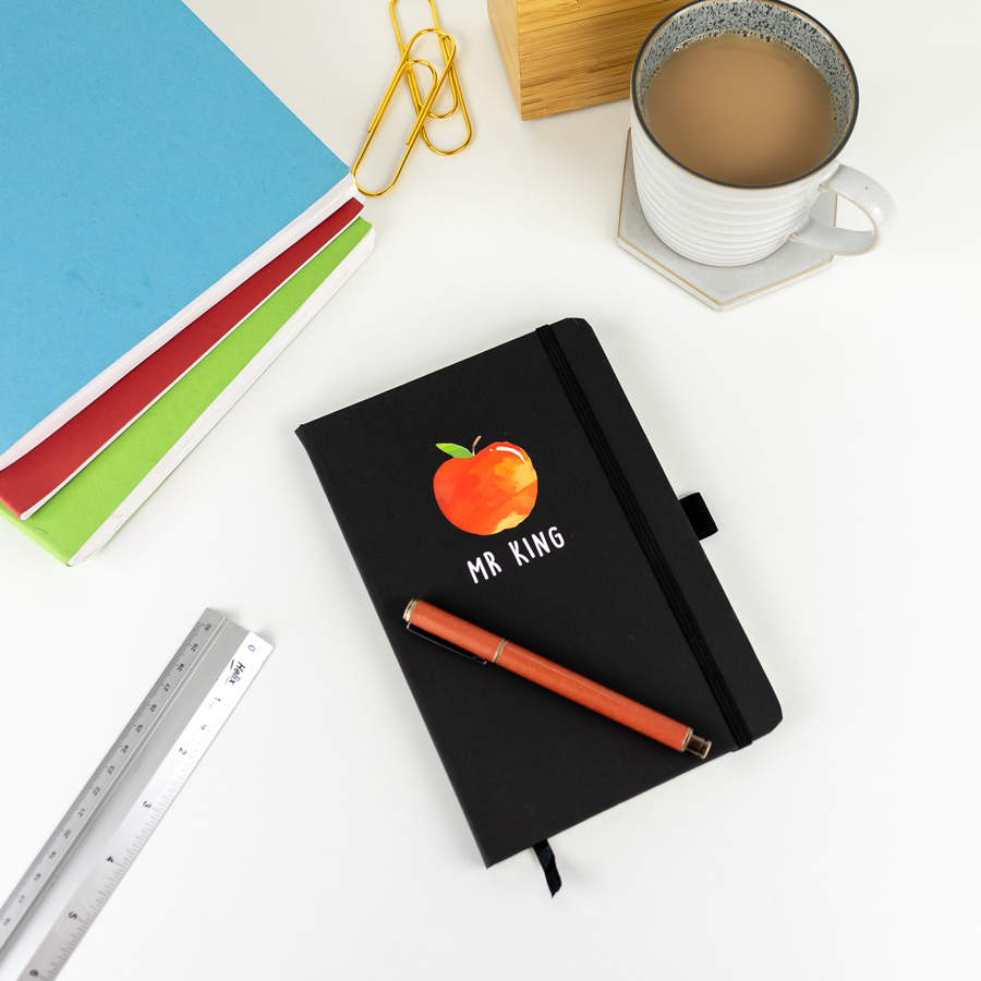 Personalised apple notebook in black features a rainbow design with personalised name underneath and is a perfect gift for a teacher or teaching assistant to say thank you