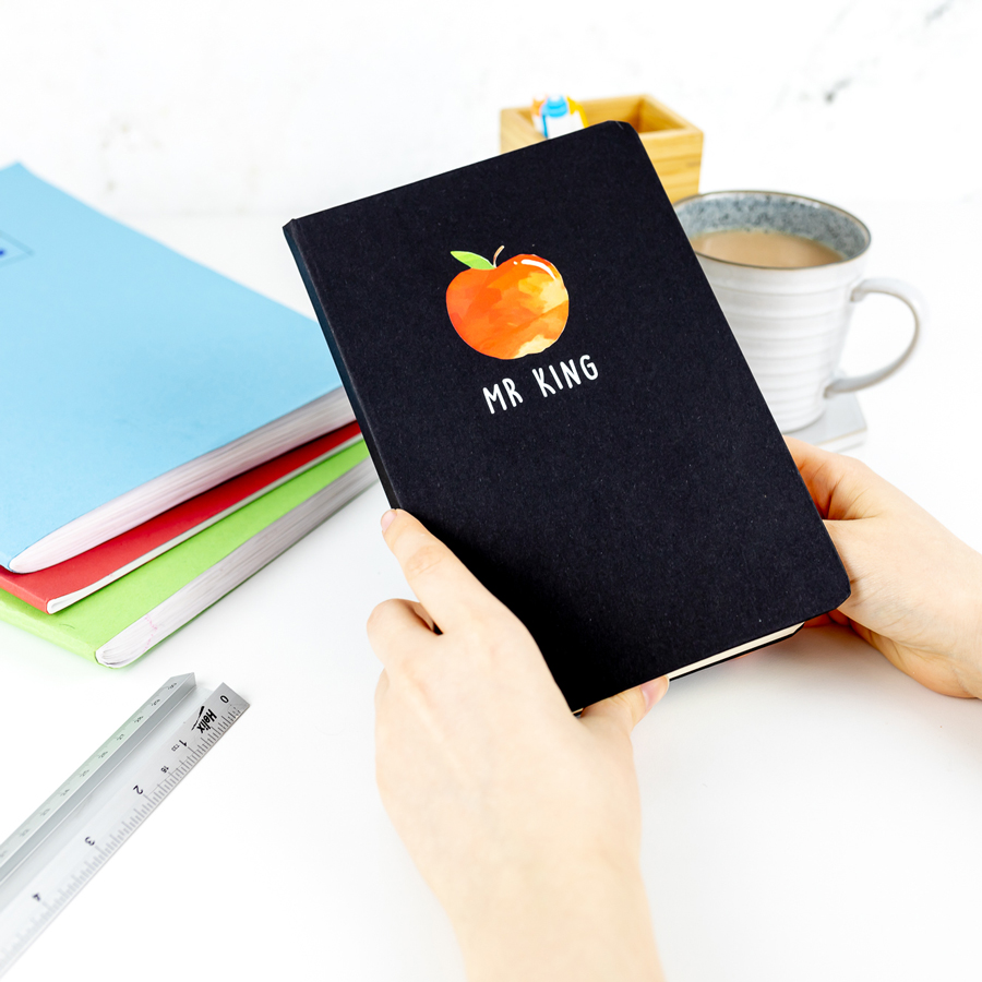 Personalised apple notebook in black features a rainbow design with personalised name underneath and is a perfect gift for a teacher or teaching assistant to say thank you