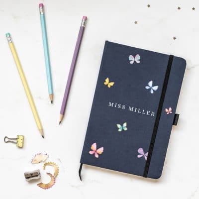 Personalised butterflies notebook in blue features six butterflies in pastel shades with the name of your choice in the centre of the notebook and is a perfect gift for a teacher or teaching assistant to say thank you