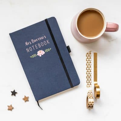 Personalised rainbow heart notebook in blue features a rainbow design with personalised name underneath and is a perfect gift for a teacher or teaching assistant to say thank you
