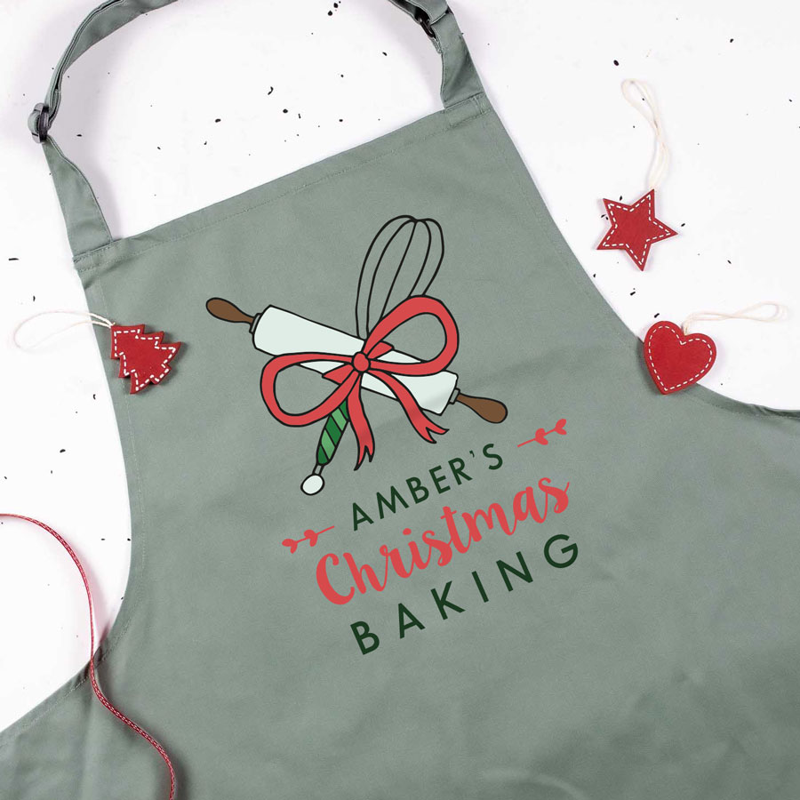 Christmas Baking apron in sage featuring whisk and rolling pin