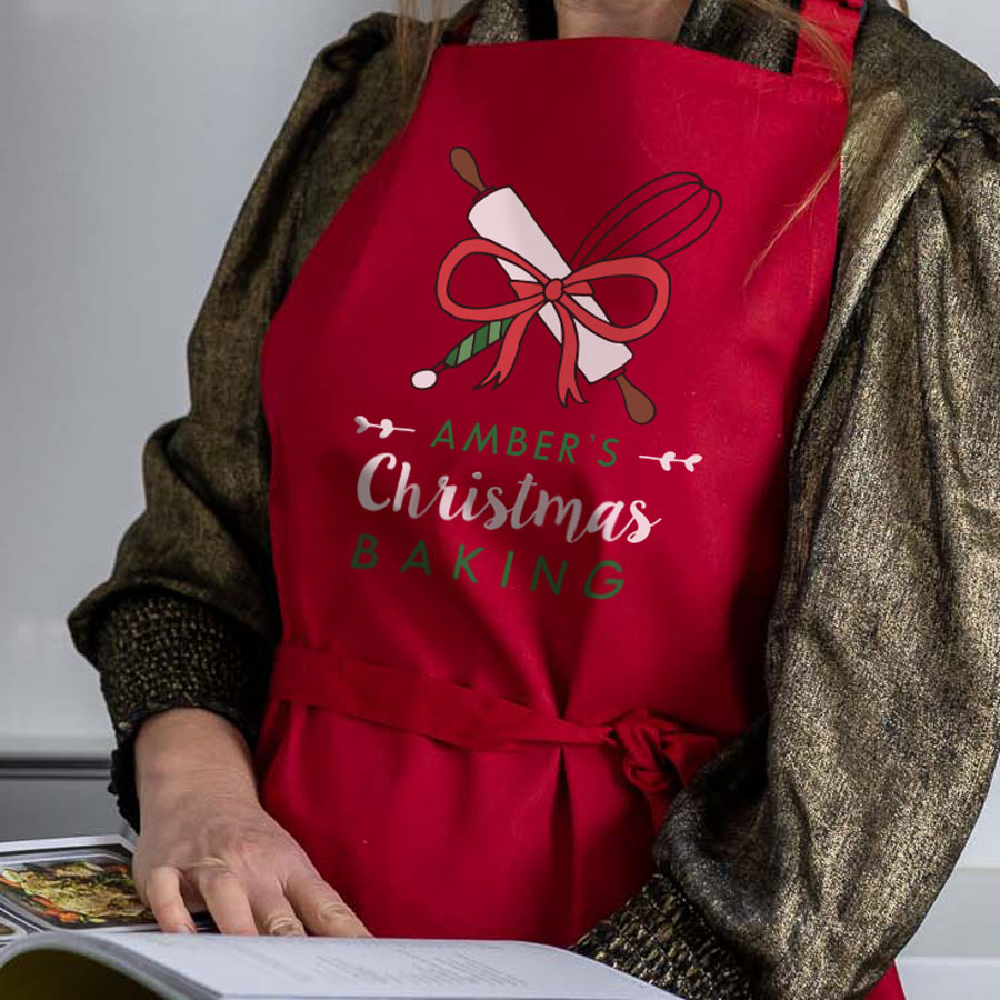 Christmas Baking apron in red featuring whisk and rolling pin