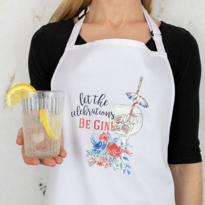 Be gin apron shown on model holding a glass with lemon and ice