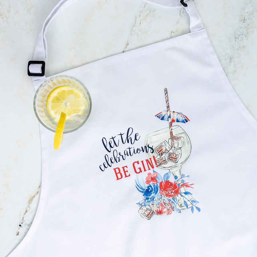 Be gin apron shown flat with a glass with ice and lemon