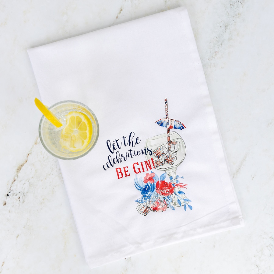 Be gin tea towel flat with a glass of ice and lemon