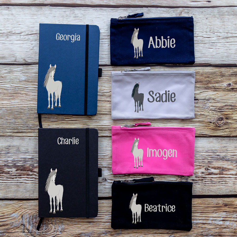 colour options for horse back to school bundles. blue/black notebook with horse illustration bottom left with name text in white at top centre. navy/grey/pink/black pencil case with image of horse on left with name text in white to the right.