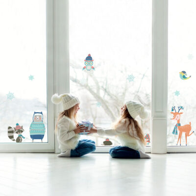 Winter Woodland Window Stickers on window behind two children