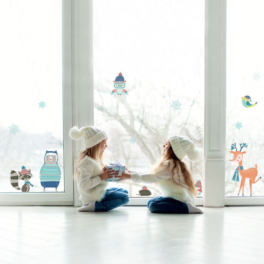 Winter Woodland Window Stickers on window behind two children