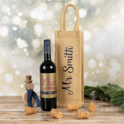 personalised bottle bag shown next to a bottle of mulled wine