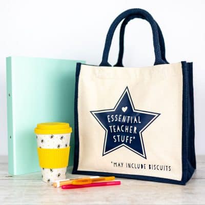 essential teacher stuff canvas bag in navy gift for teachers on a white background with folder and coffee mug