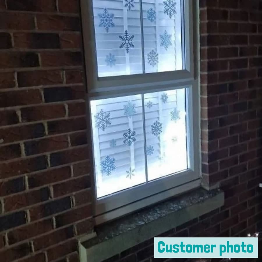 snowflake window stickers (blue and grey) on a customer's window from the outside