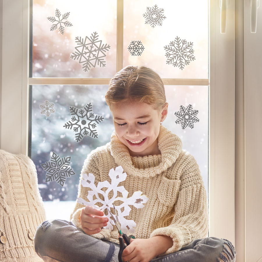 Grey Snowflake Window Stickers on window behind child