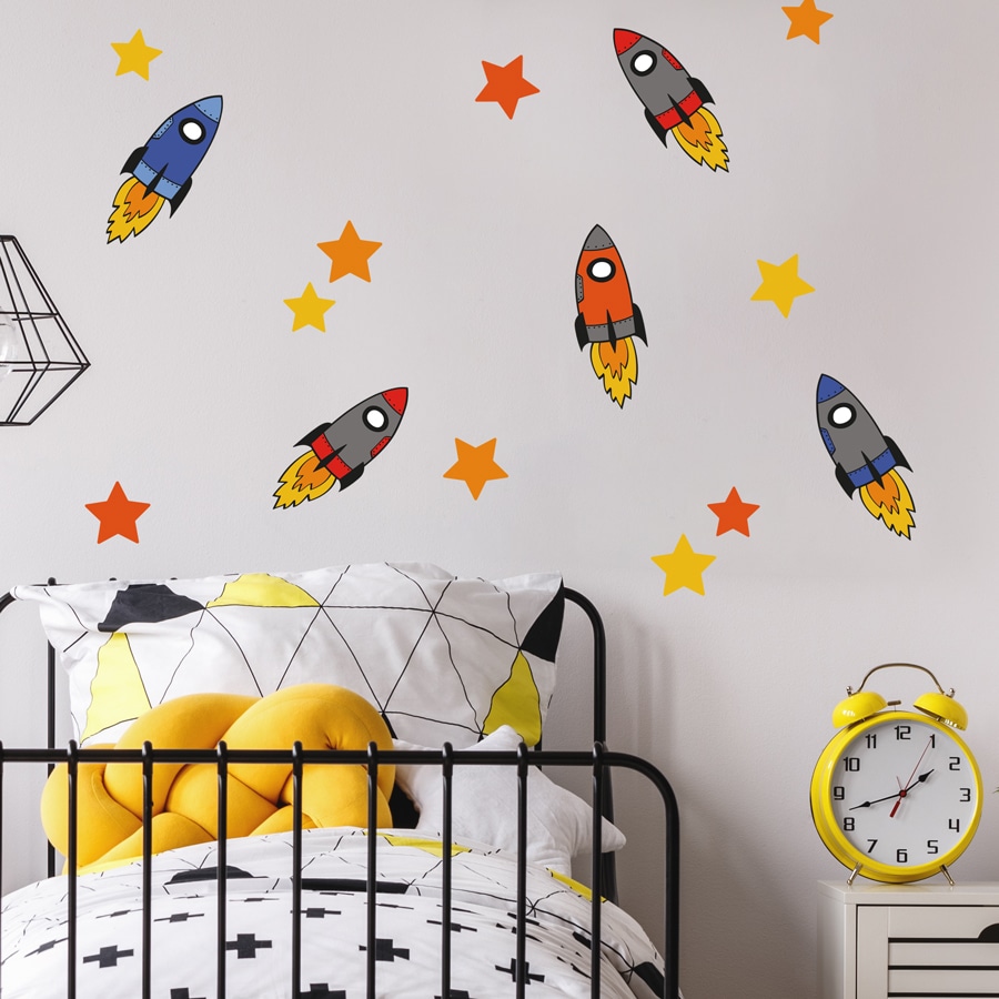colourful space rocket wall stickers above a child's bedhead