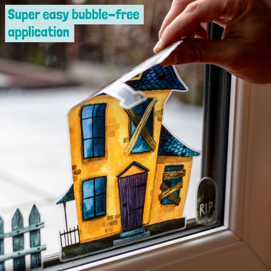 Haunted Village Window Stickers being applied to a window with bubble free application