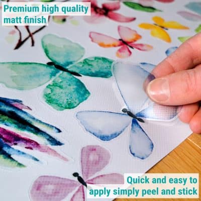 hummingbird and butterflies window stickers being removed from the backing sheet