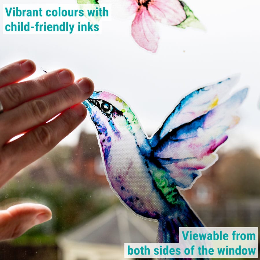 hummingbird and butterflies window sticker being applied