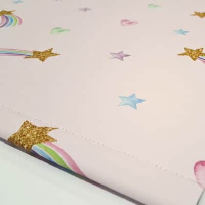 close-up of pink shooting star roller blind with bottom bar and stitching