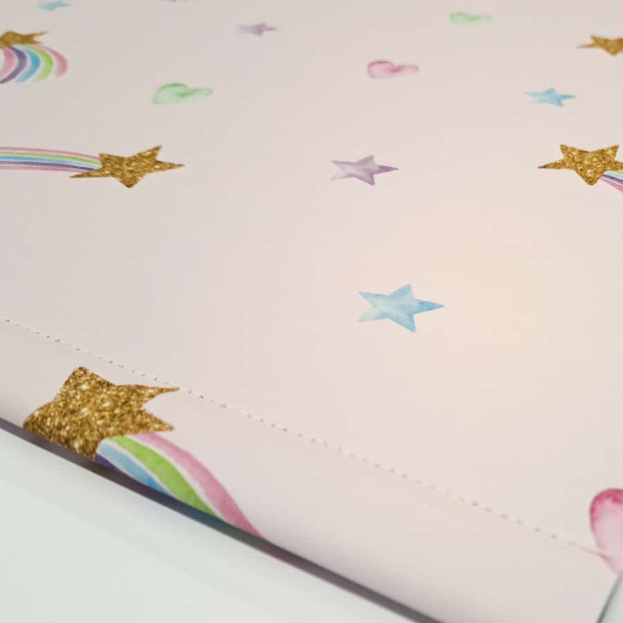 close-up of pink shooting star roller blind with bottom bar and stitching