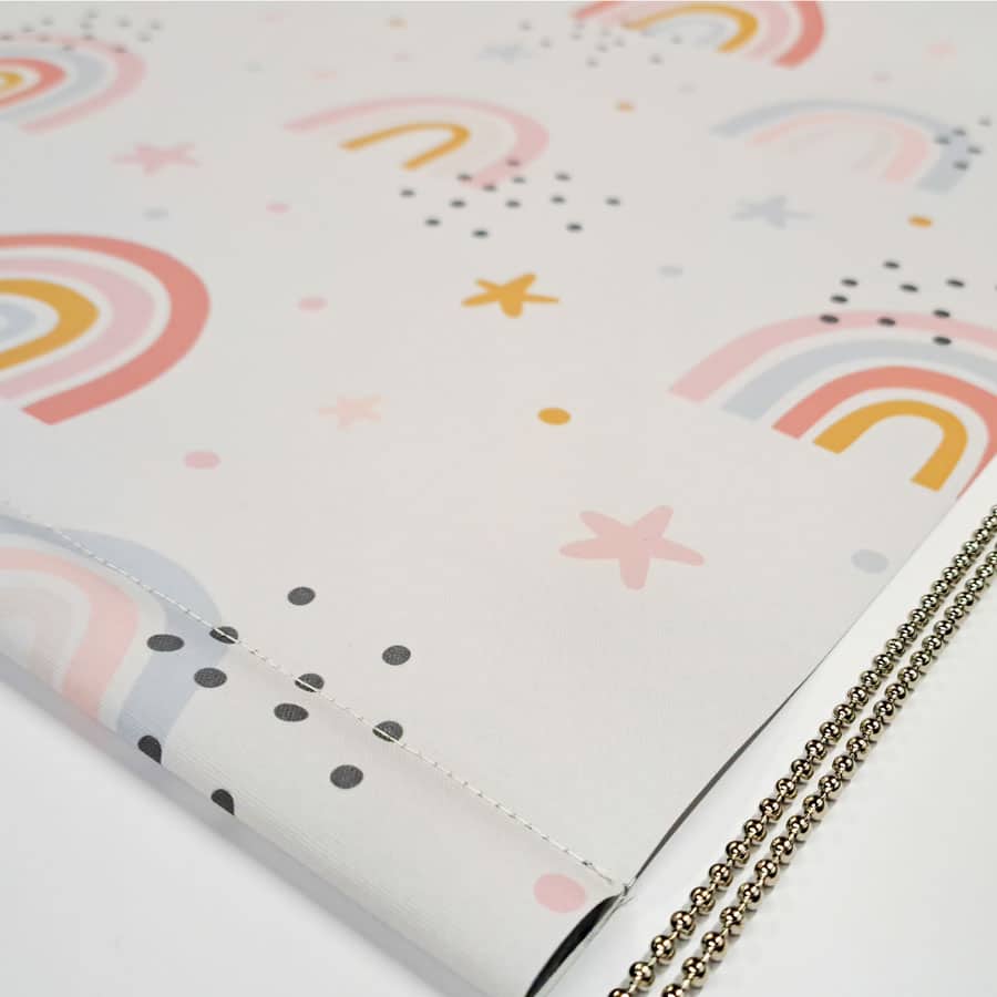 close-up of grey rainbows and stars roller blind showing bottom bar and chrome chain