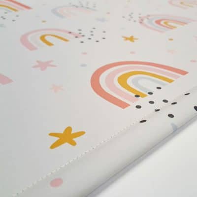 close-up of grey rainbows and stars roller blind showing bottom bar stitching