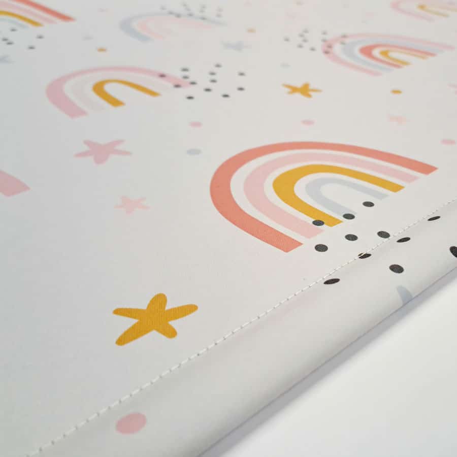 close-up of grey rainbows and stars roller blind showing bottom bar stitching