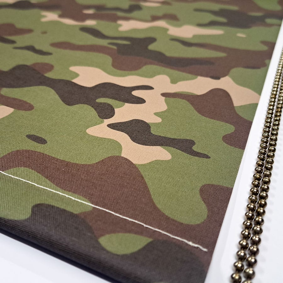 close-up of camouflage blackout blind with chrome chain and bottom bar stitching
