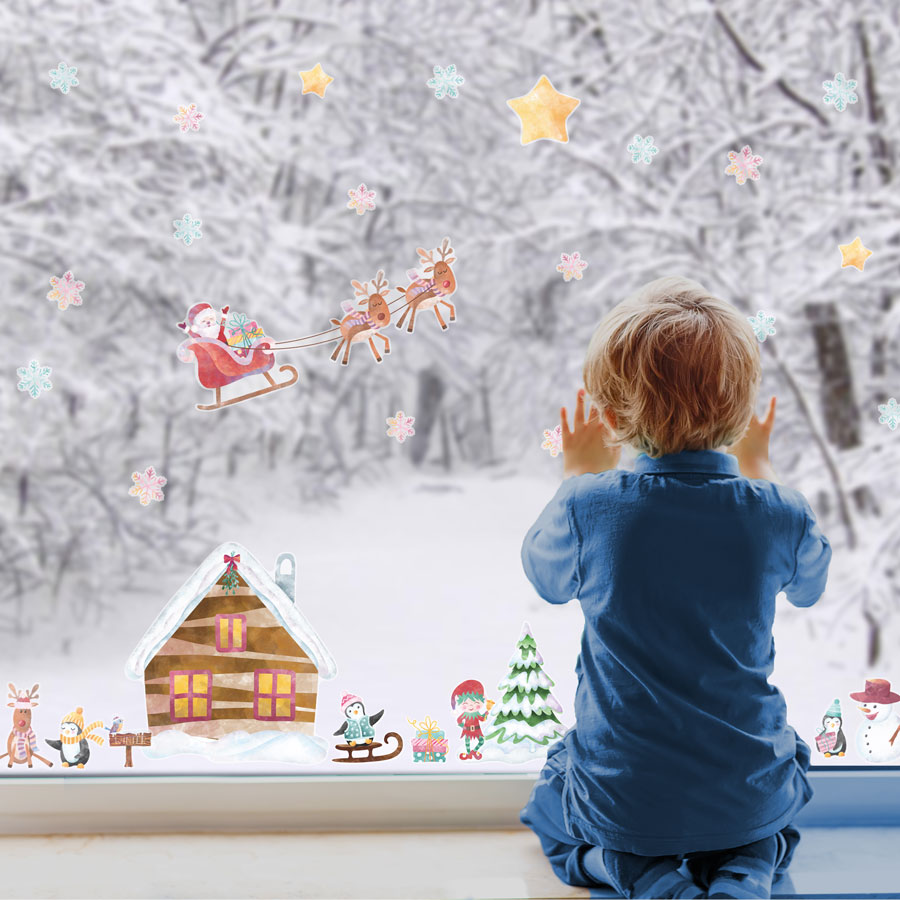 North Pole Christmas Window Stickers (Regular size) on a window with child featuring Santa, Snowflakes and other festive elements