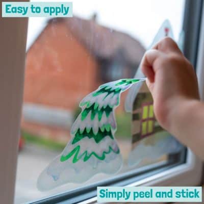 christmas tree window sticker being applied from the North Pole Christmas Window sticker pack