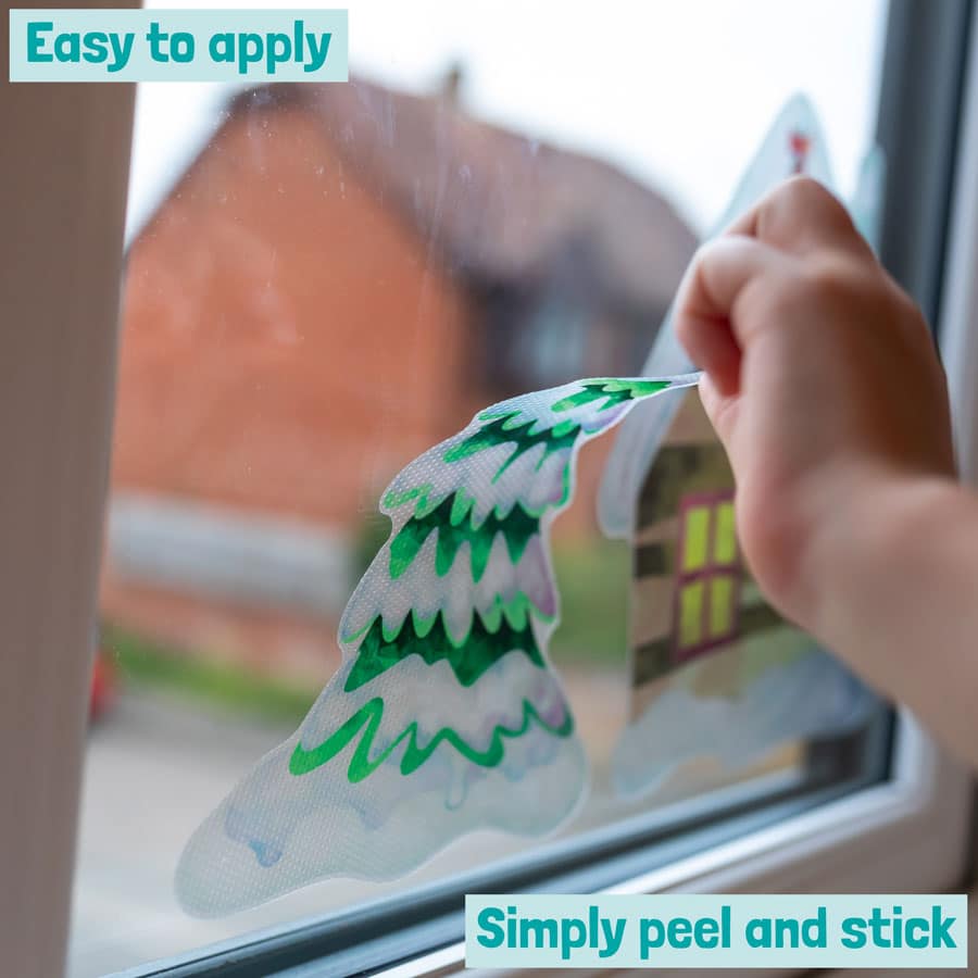 christmas tree window sticker being applied from the North Pole Christmas Window sticker pack