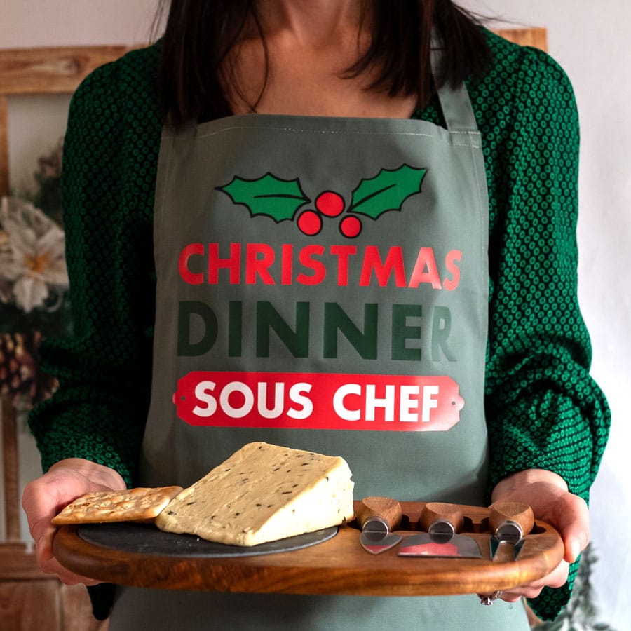 Personalised Christmas apron in sage with text sous chef on woman