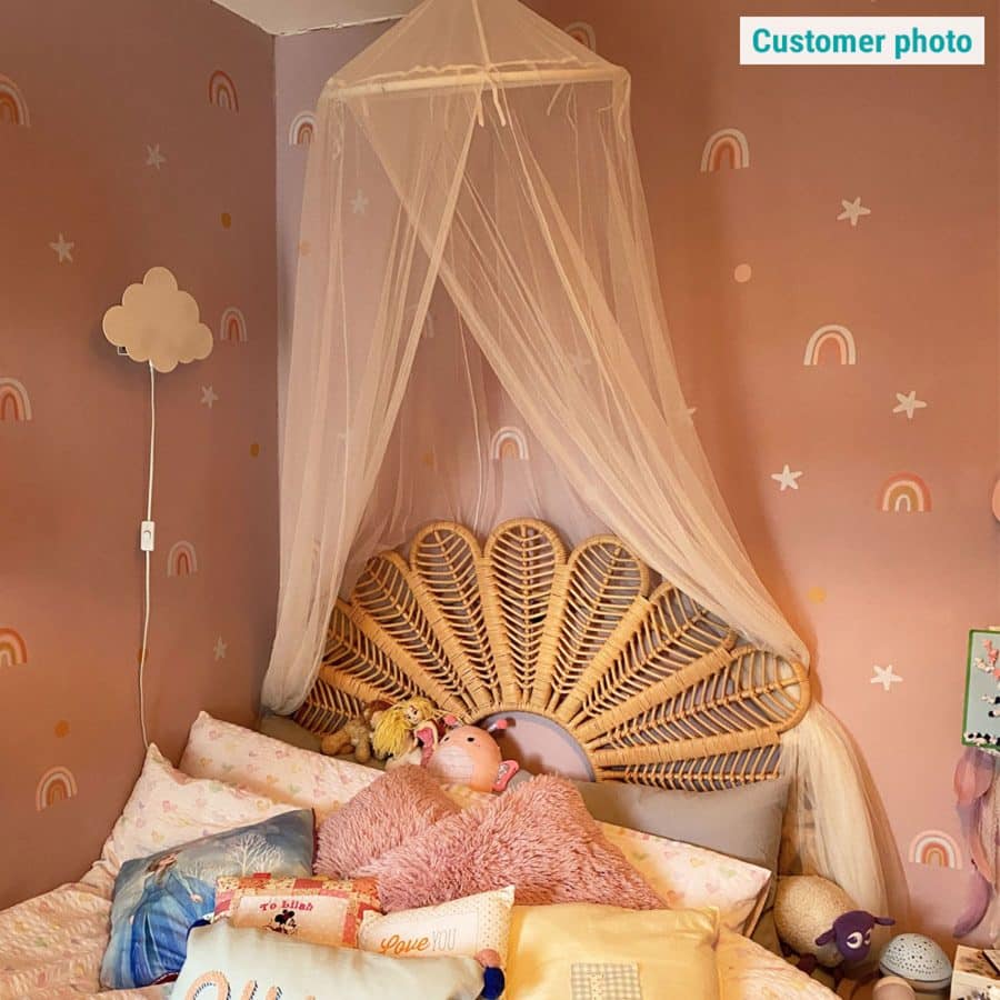 Rainbow and Stars Wall Stickers in a customer's room on a pink wall