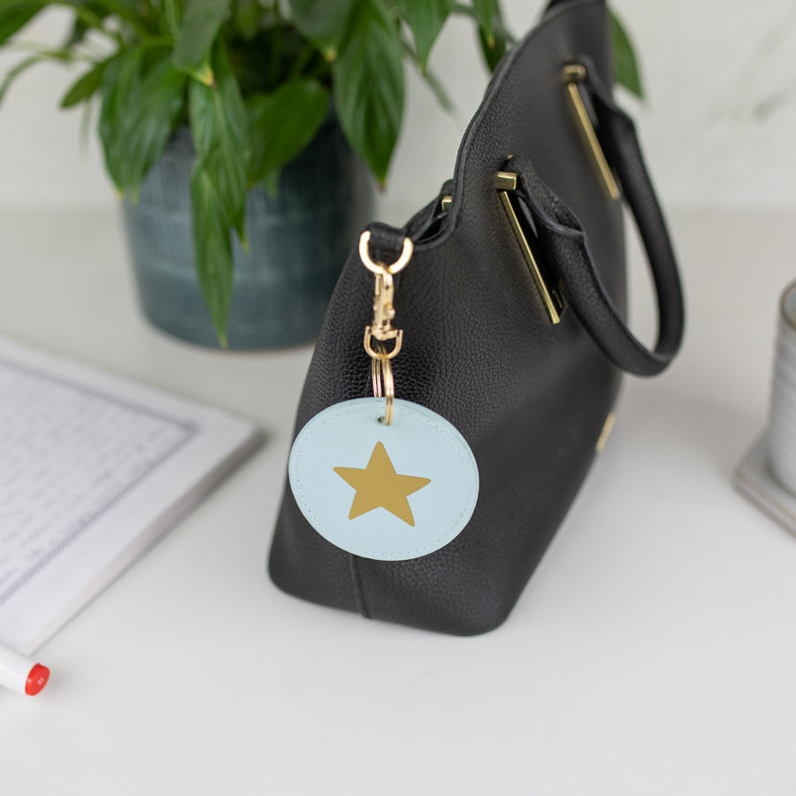 gold star keyring on blue