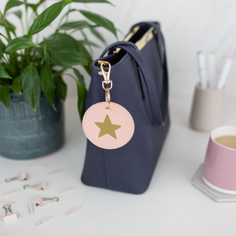 gold star keyring on pink