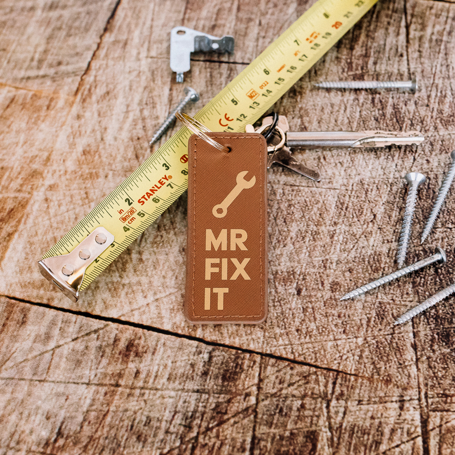 mr fix it keyring in black and gold