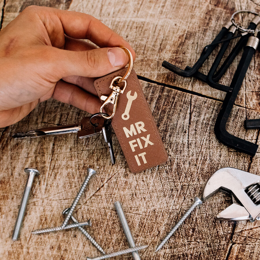 mr fix it keyring in black and gold